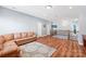 Upstairs living room showcasing hardwood floors and a comfortable leather sofa at 8504 Soaring Eagle Ln, Waxhaw, NC 28173