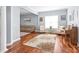 Spacious living room with hardwood floors, neutral paint, and cozy seating arrangement at 8504 Soaring Eagle Ln, Waxhaw, NC 28173