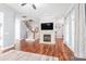 Open-concept living room with fireplace, hardwood floors, and staircase leading to the second floor at 8504 Soaring Eagle Ln, Waxhaw, NC 28173