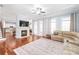 Spacious living room with fireplace, hardwood floors, and comfortable seating arrangement at 8504 Soaring Eagle Ln, Waxhaw, NC 28173