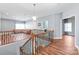 Second floor living area with open railing, hardwood floors, and access to multiple rooms at 8504 Soaring Eagle Ln, Waxhaw, NC 28173