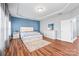 Bright main bedroom showing hardwood floors, tray ceilings, and white furnishings at 8504 Soaring Eagle Ln, Waxhaw, NC 28173