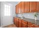 Mud room includes granite counters, wooden cabinetry, and access to a bright outdoors at 8504 Soaring Eagle Ln, Waxhaw, NC 28173