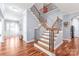 Elegant staircase with wood and iron railings leading to the upper level of the home at 8504 Soaring Eagle Ln, Waxhaw, NC 28173