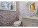 Charming powder room featuring patterned wallpaper, vessel sink, and large vanity mirror at 910 Forest Dr # 14, Lancaster, SC 29720
