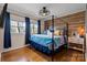 This bedroom features hardwood floors, a four poster bed, bright windows and modern light fixture at 910 Forest Dr # 14, Lancaster, SC 29720