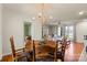 Cozy dining area featuring a wooden table, decorative chandelier, and hardwood floors flowing into the living room at 910 Forest Dr # 14, Lancaster, SC 29720