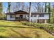 Charming exterior elevation features a covered porch, open carport, and beautiful landscaping at 910 Forest Dr # 14, Lancaster, SC 29720