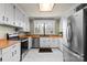 Bright kitchen with white cabinets, stainless steel appliances, wood countertops, and a window over the sink at 910 Forest Dr # 14, Lancaster, SC 29720