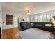 Spacious living room with a large sectional sofa, hardwood floors, and abundant natural light through the windows at 910 Forest Dr # 14, Lancaster, SC 29720