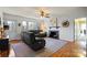 Comfortable living room with a gray sofa, fireplace, hardwood floors, and natural light from the windows at 910 Forest Dr # 14, Lancaster, SC 29720