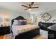 Comfortable main bedroom with a ceiling fan, dark furniture, hardwood floors, and an ensuite bathroom at 910 Forest Dr # 14, Lancaster, SC 29720