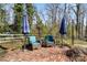 Brick patio with comfortable outdoor seating, umbrellas, and wooded views at 910 Forest Dr # 14, Lancaster, SC 29720