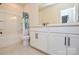 Bathroom showcasing a tub with a shower, a vanity with storage, and tiled floors at 1028 Grays Mill Rd, Charlotte, NC 28215