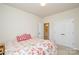 Bedroom featuring a closet, a doorway to an en-suite, and a floral patterned bed at 1028 Grays Mill Rd, Charlotte, NC 28215