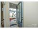 Inviting entryway with a view of the neighborhood featuring a gray front door with glass panels and a decorative rug at 1028 Grays Mill Rd, Charlotte, NC 28215