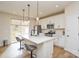Bright kitchen features white cabinets, stainless steel appliances, large island with bar seating, and a sliding door to the backyard at 1028 Grays Mill Rd, Charlotte, NC 28215