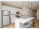 Modern kitchen with stainless steel appliances, an island with bar seating, white cabinets, and stylish pendant lighting at 1028 Grays Mill Rd, Charlotte, NC 28215