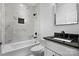 Well-lit bathroom showcasing stylish fixtures, marble tiled walls, and a modern bathtub at 105 4Th Se St, Catawba, NC 28609