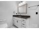 Bathroom vanity with white cabinets, granite countertop, and decorative mirror at 105 4Th Se St, Catawba, NC 28609