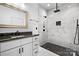 Modern bathroom featuring marble tiling, a sleek vanity, and a glass-enclosed shower at 105 4Th Se St, Catawba, NC 28609