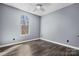 Bedroom with wood-look flooring, large window, neutral paint, and modern ceiling fan at 105 4Th Se St, Catawba, NC 28609