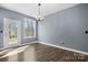 Bright dining room featuring hardwood floors, a modern chandelier, and a window at 105 4Th Se St, Catawba, NC 28609