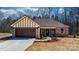 Charming brick home featuring a covered entrance, attached garage, and well-manicured lawn at 105 4Th Se St, Catawba, NC 28609
