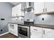 Close-up of modern kitchen with stainless steel oven, range hood, and cabinets at 105 4Th Se St, Catawba, NC 28609