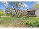 Expansive backyard with lush green grass, mature trees, and a screened-in porch at 10633 Hwy 52 Hwy, Rockwell, NC 28138