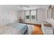 Cozy bedroom featuring hardwood floors, a desk, and natural light from large windows at 10633 Hwy 52 Hwy, Rockwell, NC 28138