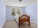 Serene bedroom with a single bed and lots of natural light, offering a calming space to rest at 10633 Hwy 52 Hwy, Rockwell, NC 28138