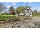 Charming home featuring landscaped front yard with stone accents, garden, and gravel driveway at 10633 Hwy 52 Hwy, Rockwell, NC 28138