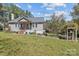 Charming one story home featuring a welcoming front porch, landscaped yard, and lovely blue sky at 10633 Hwy 52 Hwy, Rockwell, NC 28138