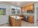 Functional kitchen with wood cabinets, granite counters, stainless steel appliances, and wood plank ceiling at 10633 Hwy 52 Hwy, Rockwell, NC 28138