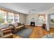 Inviting living room with a cozy fireplace, hardwood floors, and lots of natural light at 10633 Hwy 52 Hwy, Rockwell, NC 28138