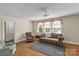 Spacious living room with hardwood floors, large windows, and comfortable seating at 10633 Hwy 52 Hwy, Rockwell, NC 28138
