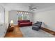 Cozy living room featuring a comfortable sofa, ceiling fan, and beautiful hardwood floors at 10633 Hwy 52 Hwy, Rockwell, NC 28138