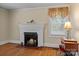 Charming living room showcasing a brick fireplace, hardwood floors, and natural light at 10633 Hwy 52 Hwy, Rockwell, NC 28138