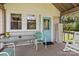Covered outdoor porch showcasing a blue door, and a table with seating, great for relaxing at 10633 Hwy 52 Hwy, Rockwell, NC 28138