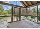 Screened porch with view of backyard and filled with white and green outdoor chairs at 10633 Hwy 52 Hwy, Rockwell, NC 28138
