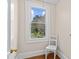 Charming room with a white chair and a large window showing a beautiful landscape view at 10633 Hwy 52 Hwy, Rockwell, NC 28138