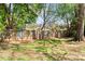Backyard featuring a wood fence, mature trees, and playground equipment at 11416 Leadenhall Ln # 22, Charlotte, NC 28262