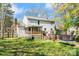 Expansive backyard with lush green grass, a trampoline, wooden deck, and a charming two-story home at 11416 Leadenhall Ln # 22, Charlotte, NC 28262