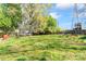 Large backyard with mature trees, a trampoline, a wooden fence, and a play structure at 11416 Leadenhall Ln # 22, Charlotte, NC 28262