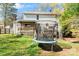 Spacious backyard featuring a trampoline, wooden deck, and a charming two-story home with white siding at 11416 Leadenhall Ln # 22, Charlotte, NC 28262
