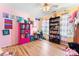 Bright bedroom with colorful walls, featuring a desk, shelves, and a window view for a playful ambiance at 11416 Leadenhall Ln # 22, Charlotte, NC 28262