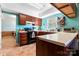This kitchen features beautiful natural light, wood cabinets and durable tile floors at 11416 Leadenhall Ln # 22, Charlotte, NC 28262
