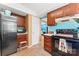 This kitchen features a stainless fridge, black oven and wood cabinets at 11416 Leadenhall Ln # 22, Charlotte, NC 28262