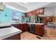 This bright kitchen features beautiful natural light, wood cabinets and durable tile floors at 11416 Leadenhall Ln # 22, Charlotte, NC 28262
